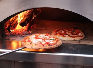 baking pizza in a pizza oven outdoors